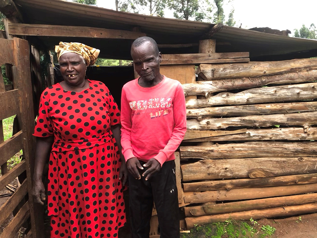 Teresia and Daniel outside their pig enclosure. © Julianne Stewart/AID.