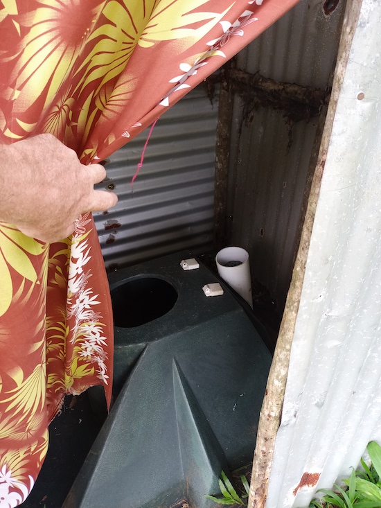 This toilet was installed at a vulnerable household in Tanbok community in 2023 after Cyclone Kevin but before Cyclone Lola. The toilet seat and part of the ventilation pipe were lost during Cyclone Lola but the toilet itself remained fully intact and the owners quickly rebuilt the toilet walls so they could continue using the toilet. © Terry Russell, AID.