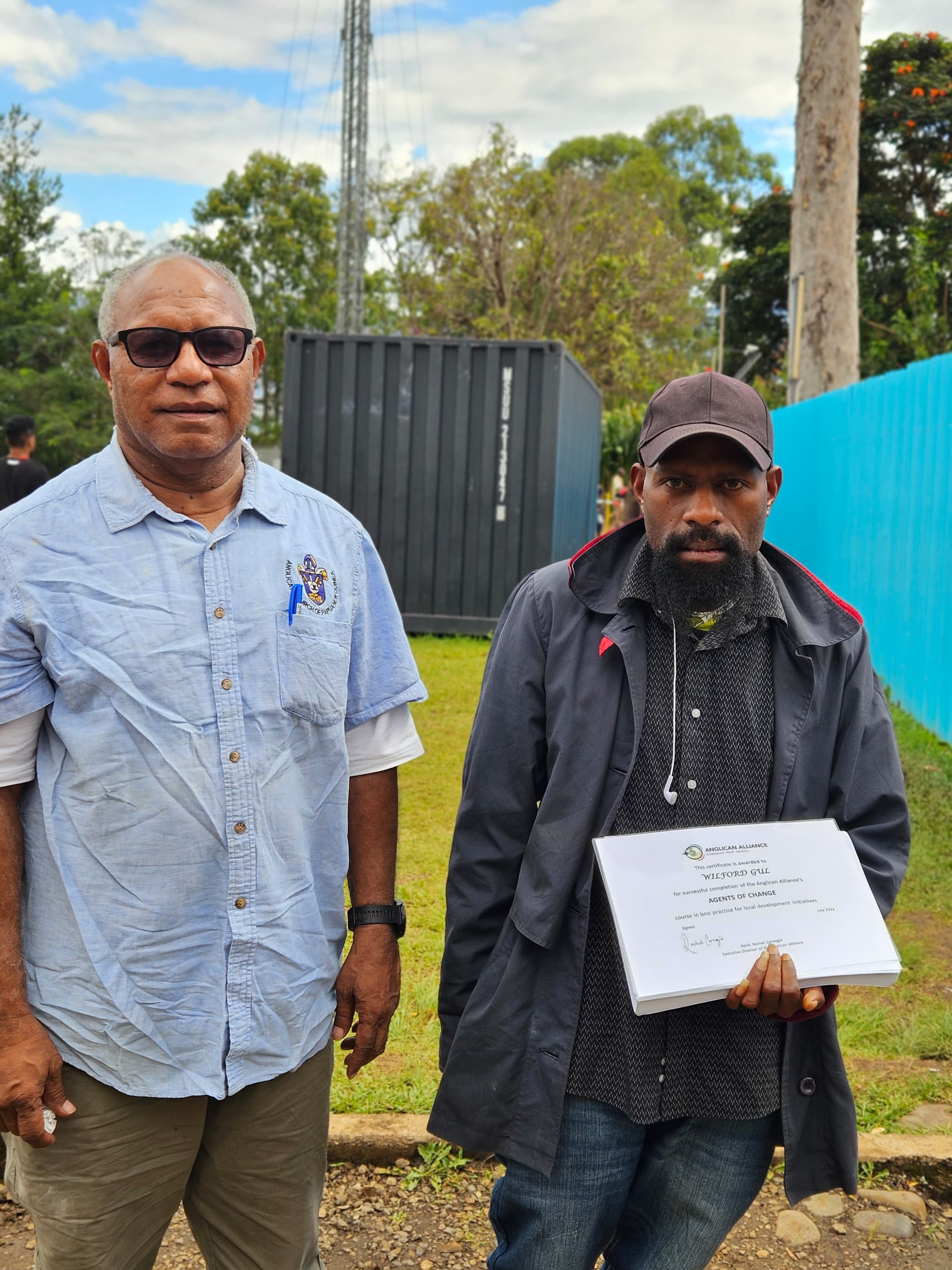 Mareng Youth Ministry member accepts graduation certificates on behalf of the group © ACPNG. Used with permission.