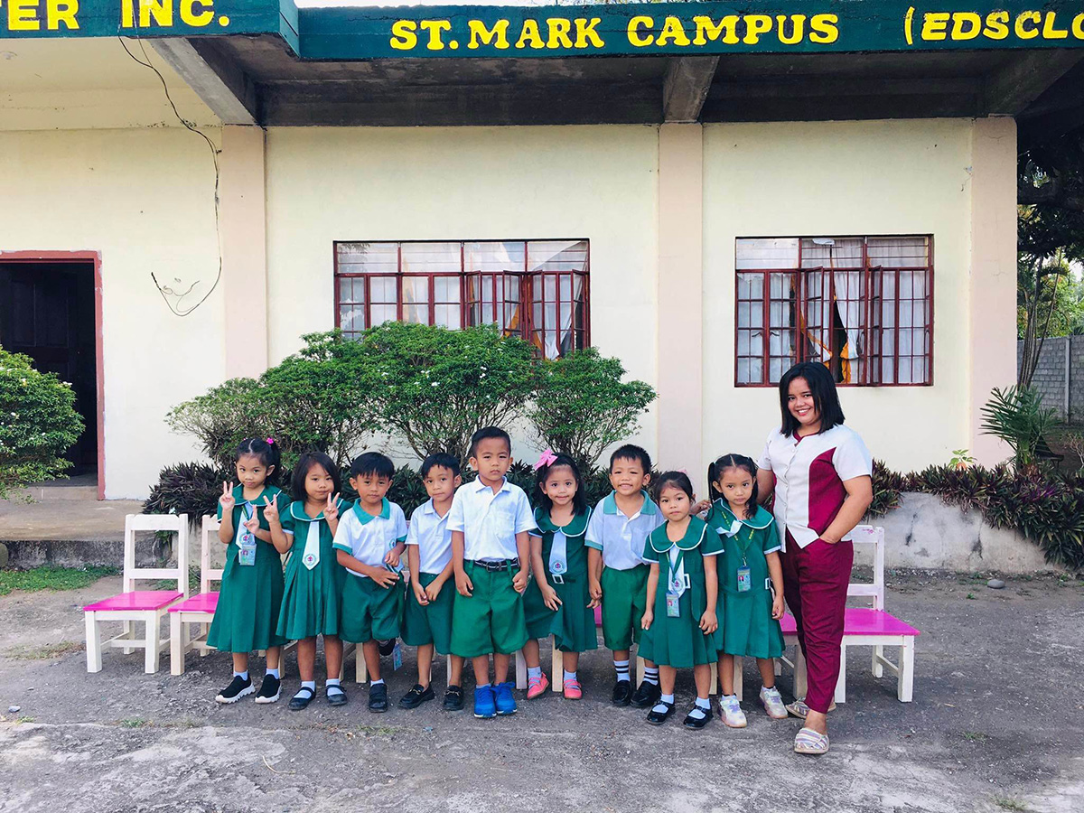 Young children at the school with their teacher.