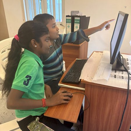 Two children learn computer skills at the Diocese of Colombo’s Oppuravillam Centre. © Simolyn Delgado/ABM.