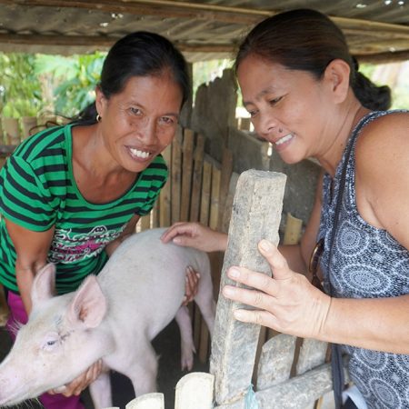 Oliva and Esmerelda with a happy and healthy piglet raised using the LEISA method. © IFI-VIMROD. Used with permission.