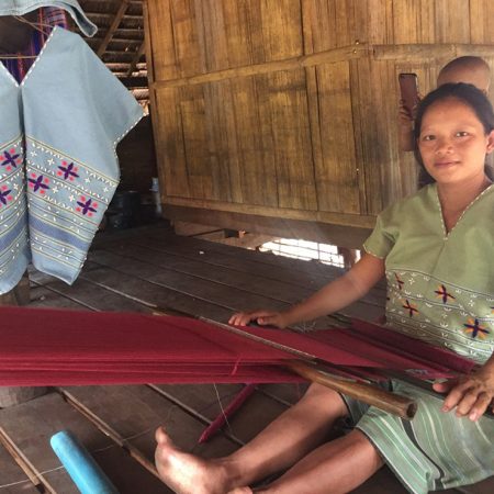 Naw Pat K’law with her new loom on which she weaves beautiful fabric and makes an income for her family. © CPM. Used with permission.