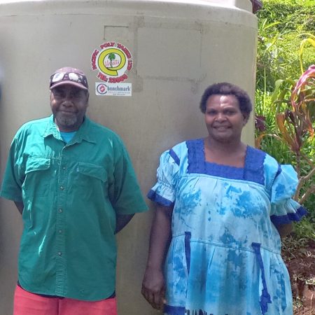 This water tank in Enkul on Pentecost Island is being checked by Sofer and Esline. © ACOM-V. Used with permission.