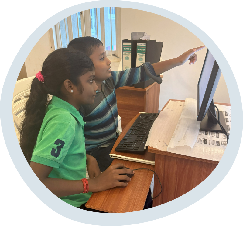 Two children learn computer skills at the Diocese of Colombo’s Oppuravillam Centre. © Simolyn Delgado/ABM.